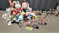 Wide view of the assortment of plush toys, small figurines, and keychain accessories, showing variety and quantity of items