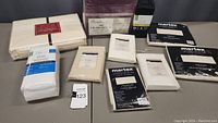 Complete lot of new bedding items including twin and queen sheets, pillowcases, a queen bed skirt, and packaged duvet covers.
