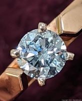 Close-up front view of round brilliant cut diamond and band