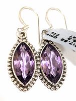 Front view of both silver earrings showing marquise amethyst stones with beaded silver borders.