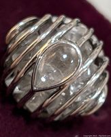 Close-up front view of the sterling silver ring showcasing the pear-shaped moonstone and surrounding silver bars.