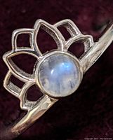 Close-up image of the sterling silver ring showing the moonstone and lotus flower design