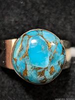 Close-up top view of the turquoise stone set in sterling silver ring.