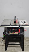 Front view of Craftsman table saw with power cord, metal table top, blade guard and adjustment dials visible.