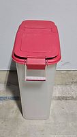 Front view of tall rectangular dog food container with red lid closed