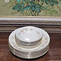 Stacked Homer Laughlin soup/pasta and dessert bowls showing floral pattern and gold rim.