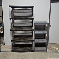 Photo showing both plastic storage shelves side by side; larger with four shelves and smaller with three shelves.
