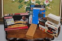 Shows the full lot including the Craftsman template kit, Black & Decker Mouse sander box, sanding sheets, sharpener box, and replacement pads.