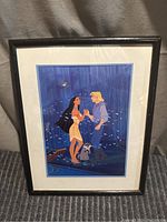 Full view of framed print showing Pocahontas and John Smith in forest setting with black frame.