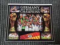 Front view of Germany 2014 World Cup Champions print on a grey textured background.