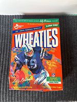Front view of Wheaties box showing Johnny Unitas football artwork and cereal details.