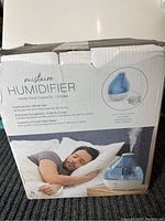 Box front showing Mistaire Humidifier branding, product image, capacity, and benefits information.