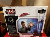 Front and side views of the sealed box showing product name, branding, and features