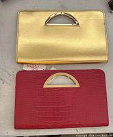 Two rectangular handbags: one metallic gold with a semi-circle gold-tone handle and one red with faux crocodile pattern and matching handle.