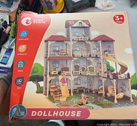 Box front showing the assembled Cute Stone Dollhouse with its features and recommended age
