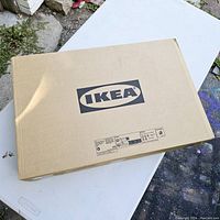 Box showing IKEA branding and sealed condition, indicating item is new and unused.