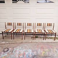 Front view of five chairs in a row against garage door
