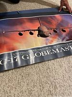 C-17 Globemaster poster showing aircraft flying at sunset, title text at bottom