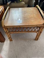 Front and top angle view of the square bamboo and wicker accent table, showing the wooden top and bamboo frame with wicker lattice sides.