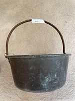 Top view of the old copper bucket showing the overall shape and metal handle.