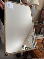 Desk mirror with metal frame showing intricate floral and leaf patterns, 15x24 inches