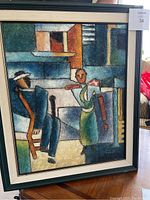 Full image of the framed artwork showing two abstract human figures in blue, green, orange, and beige tones on a textured canvas.