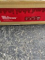 Close-up photo of original For Living box with label showing 6.5 foot Nordic prelit tree specifications including 250 clear lights and 481 tips.