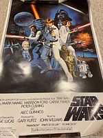 Full front view of Star Wars movie poster showing characters and text credits.