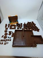 Full layout of all brown plastic building blocks and connectors for Dungeons and Dragons tabletop game set.