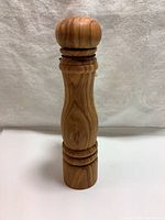 Front view of Swissmar Roma solid olive wood pepper mill showing natural grain and carved rings.