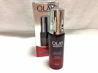 Front view of Olay Regenerist Miracle Concentrate bottle with its original box showing brand and product name.