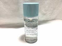 Front view of the Shiseido cleansing lotion bottle showing black printed text on clear bottle with light blue cap.