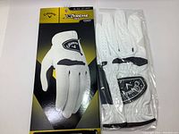 Photo shows the Callaway Xtreme 365 Men's Golf Glove in size XL, left hand, new in packaging alongside the glove outside of packaging, front view.