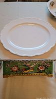 Photo showing plain white oval platter with scalloped edges laid flat