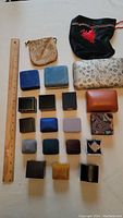 Top view of 20 assorted jewelry and ring boxes along with 2 fabric pouches and ruler for scale.