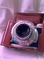 Front view of Kodak 35 camera lens in leather case, shows lens markings and leather texture