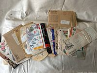 Collection of vintage transfer pattern envelopes and packets laid out on a white surface.