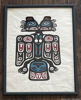 Framed silkscreen print of a Thunderbird with black, red, and blue design on textured paper.