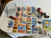 Top-down view of the die cast toys and collectibles arranged on table showing variety and packaging