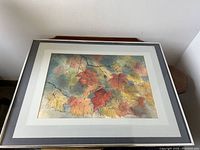 Overall view of Edwin Chon watercolor painting showing colorful maple leaves on branches, matted and framed.