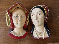 Frontal image of two vintage Bossons ceramic wall plaques featuring Anne Boleyn and Catherine of Aragon busts.