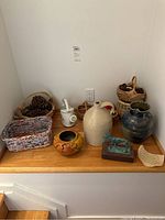 Full lot displayed on wooden corner with all pottery and baskets shown