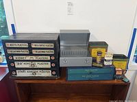 Full view of all vintage medical containers and storage boxes on wooden cabinet