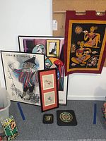 Full view of the wall art collection including framed posters, tapestry, and wall plaques
