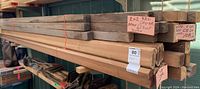 Stack of 2x2 red cedar lumber pieces labeled approximately 61 feet in length bundled together.