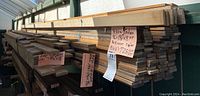 Long view of stacked cedar trim boards on shelving