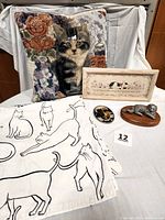 Photo showing entire lot: two tapestry pillows with kittens and flowers, white shower curtain with black cat outlines, pewter cat figurine on wood base, framed cat picture, and small stained glass cat ornament.