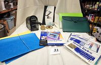 View of all items including pencil sharpener, brass clip and selector, Avery dividers, hanging files, poly portfolios, inkjet paper box, and Rolodex folder