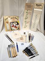 Complete display of all stencil brushes, stencil patterns, and gold embossing powder showing the entire assortment.