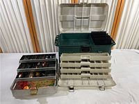 Large green plastic tacklebox with open lid and multiple compartments visible